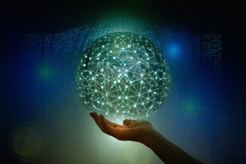 A glowing sphere in a hand with binary code